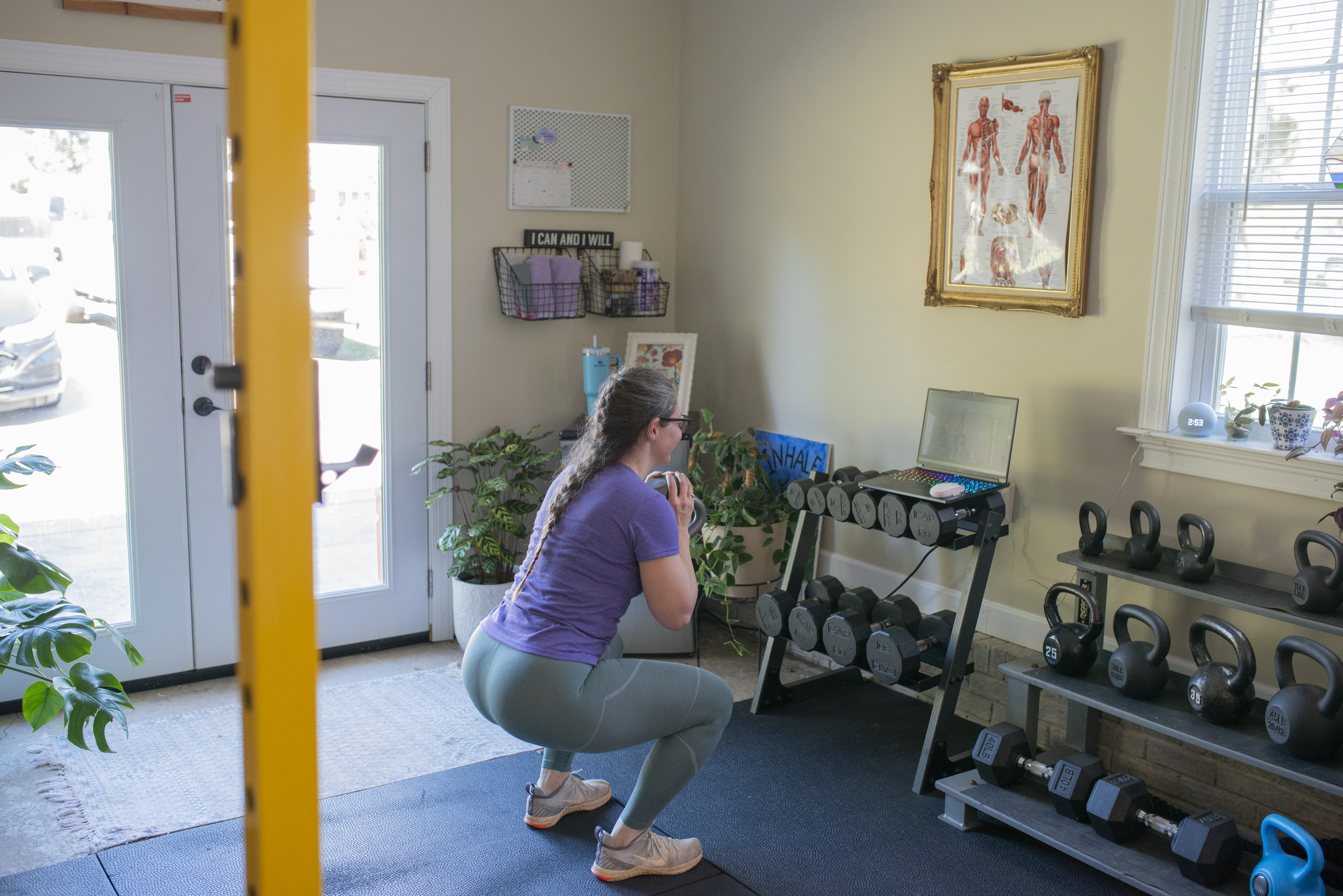 fitness coach demoing a movement for a client during a virtual training session